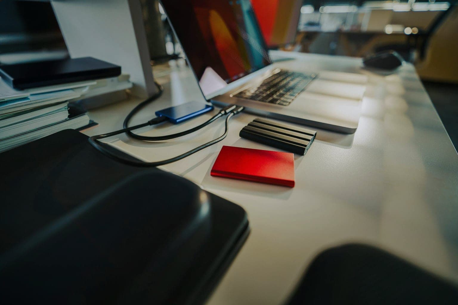 Laptop workspace with external drives representing backup and storage workflow for a small business WordPress site.